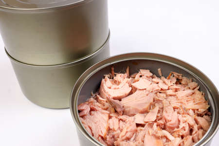 Tuna fish meat flaky chunk in tin can on white backgroundの写真素材