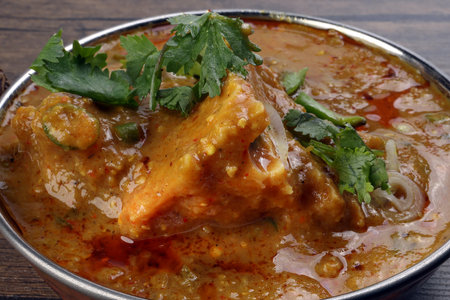 Haleem stew wheat barley lentils mutton goat chicken beef meat bone spice served in a copper brass...