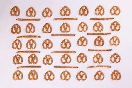 Pretzel cracker sticks laid in rows design angle straight on what backgroundの写真素材