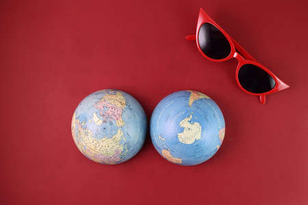 Vaccine passport Malaysia red sunglass world atlas globe map north south pole on red paper background world travel tour vacation mini human figures medical needle syringe bottleの写真素材