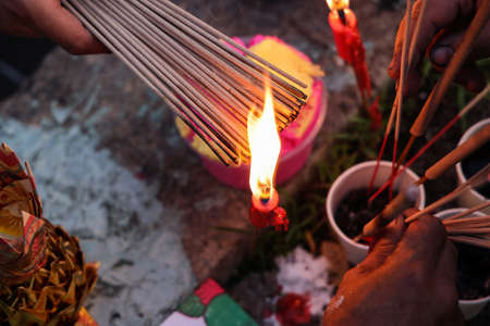 Chinese hungry ghost festival burning flame fire colourful variety prayer paper joss money fake...