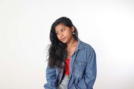 Young attractive Asian Indian woman pose face body expression mode emotion on white background look...