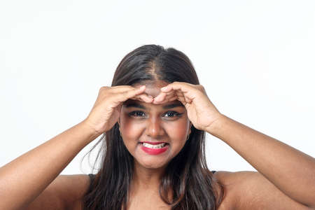 Young attractive Asian Indian woman pose face body expression mode emotion on white background hand on forehead look seeの写真素材