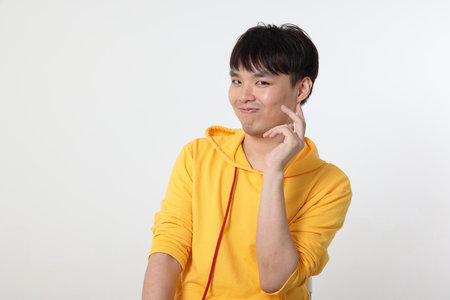 Young good looking Asian chinese malay man pose face body expression mode emotion on white background witty funny smile sexy hiの写真素材