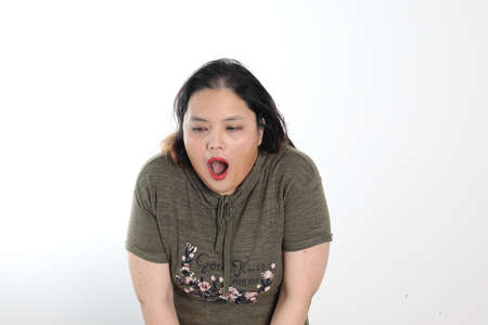 Young plus size south east asian woman pose face expression emotion on white background disgusting