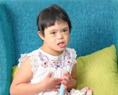 Southeast Asian child girl female special need medical down adhd autism syndrome look happy smile...