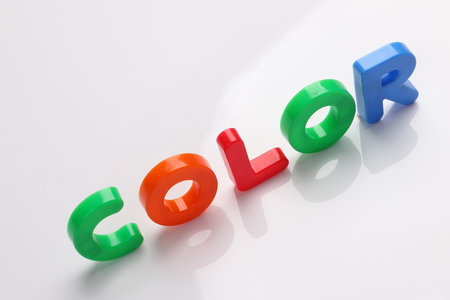red green blue yellow plastic toy capital font letter alphabet color on white background copy text space conceptの写真素材