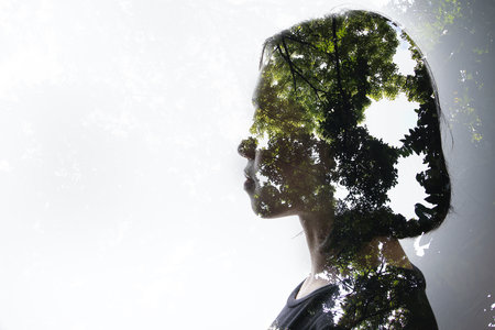 Double exposure woman on white background and outdoor nature tree plantsの写真素材