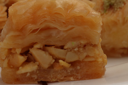 Layered stuffed pastry Baklava middle eastern sweet dessert on white backgroundの写真素材