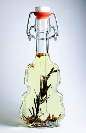 Bottle in form of violin with olive oil and spices.の写真素材