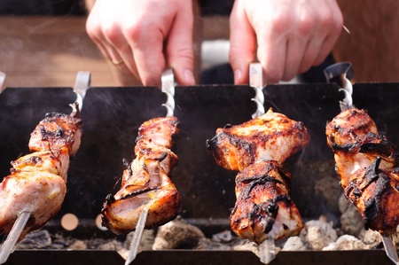 Meat are grilled on skewers の写真素材