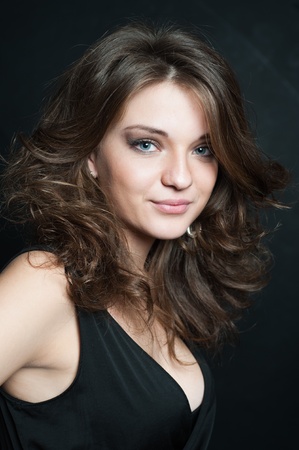 Beautiful brunette posed on black background の写真素材
