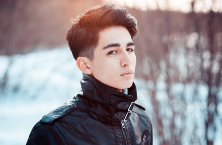 portrait of a young man in light of evening sunの写真素材