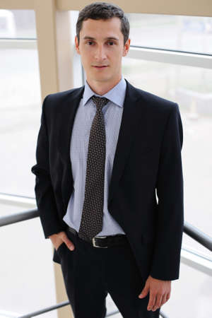 Portrait of young manager in black jacketの写真素材