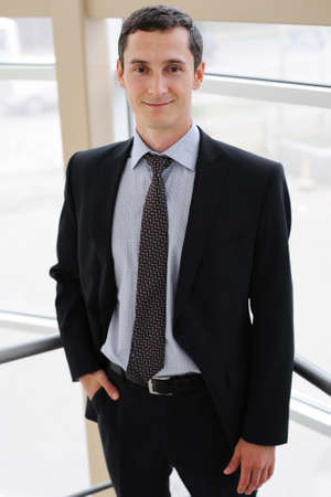 Portrait of young manager in black jacketの写真素材