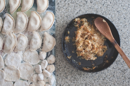 raw dumplings and stuffing for dumplings of cabbage, carrots and mashed potatoesの写真素材