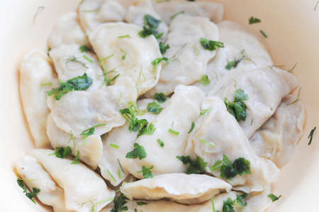 freshly dumplings on a plate with greensの写真素材