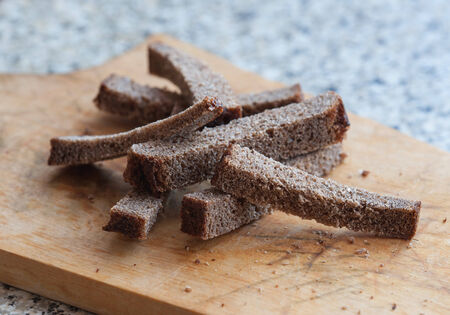 Rye croutons close up on the wooden cutting boardの写真素材