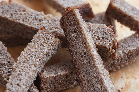 Rye croutons close up on the wooden cutting board