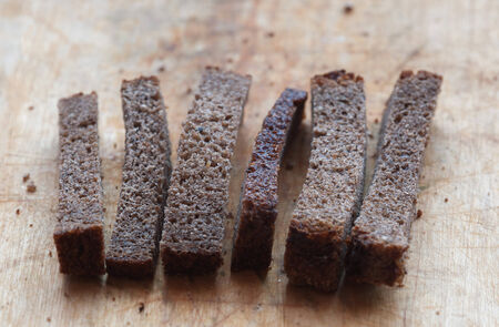 Rye croutons close up on the wooden cutting board