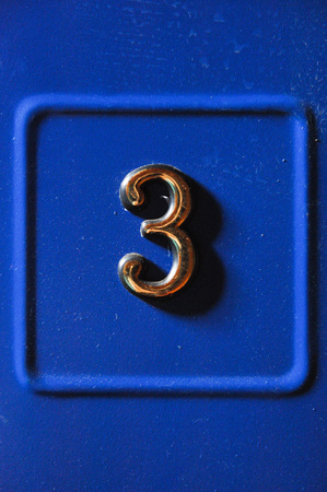 Number 3 close up on blue backgroundの写真素材
