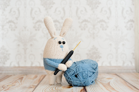 Rabbit toy knitted in the technique of knitting amigurumiの写真素材