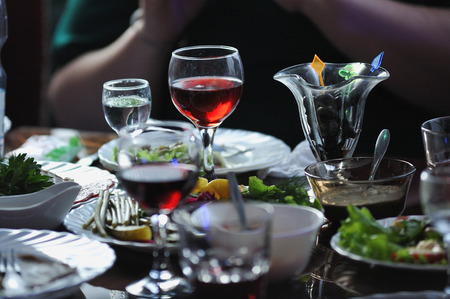Table in the restaurant with snacks and glasses of red wine.の写真素材