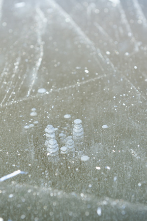 Air bubbles frozen in the water in a bizarre form .の写真素材