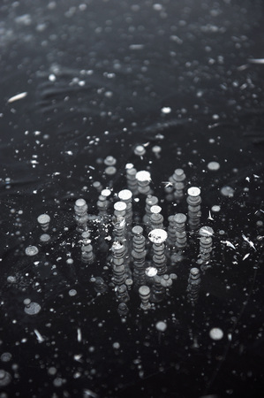 Air bubbles frozen in the water in a bizarre form .の写真素材