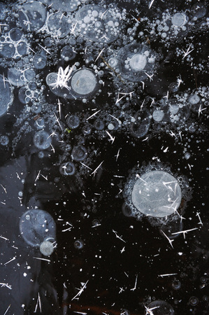 Air bubbles frozen in the water in a bizarre form .の写真素材