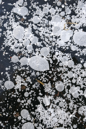 Air bubbles frozen in the water in a bizarre form .の写真素材