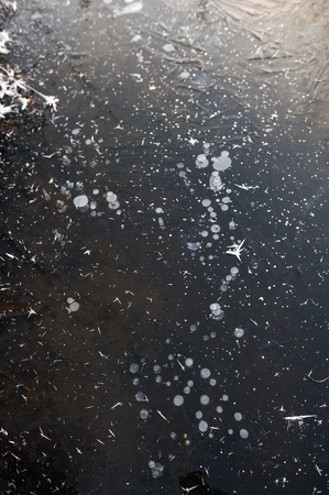 Air bubbles frozen in the water in a bizarre form .の写真素材
