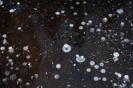 Air bubbles frozen in the water in a bizarre form .の写真素材