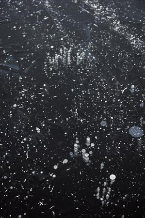Air bubbles frozen in the water in a bizarre form .の写真素材