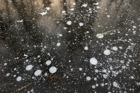 Air bubbles frozen in the water in a bizarre form .の写真素材