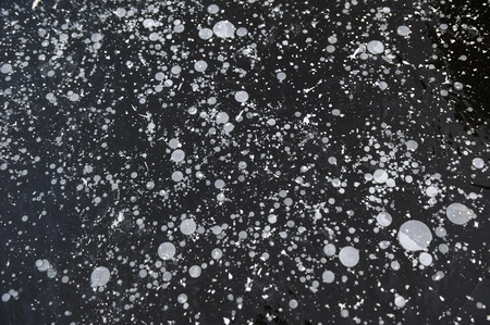 Air bubbles frozen in the water in a bizarre form .の写真素材