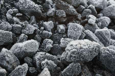 A pile of coal covered with thick crystals of frost.の写真素材
