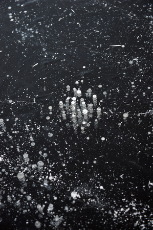 Air bubbles frozen in the water in a bizarre form .の写真素材
