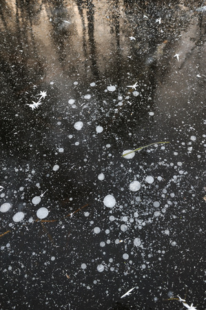 Air bubbles frozen in the water in a bizarre form .の写真素材