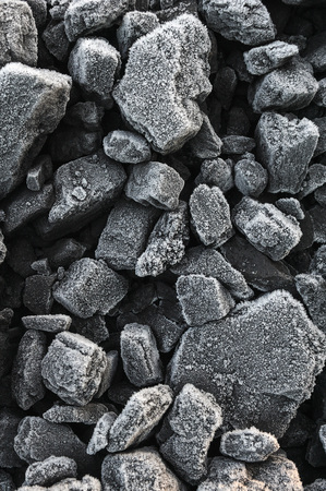 A pile of coal covered with thick crystals of frost.の写真素材
