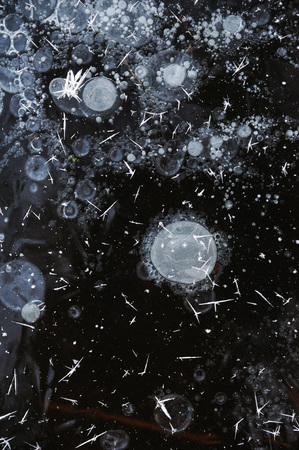 Air bubbles frozen in the water in a bizarre form .の写真素材