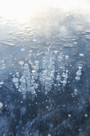 Air bubbles frozen in the water in a bizarre form .の写真素材