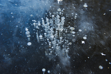 Air bubbles frozen in the water in a bizarre form .の写真素材