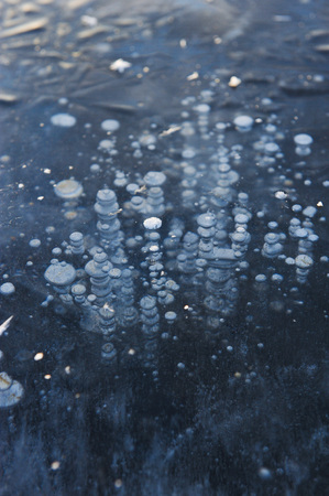 Air bubbles frozen in the water in a bizarre form .の写真素材