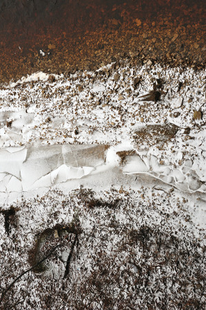 Shards of ice on the stone bank of the river in late autumn.の写真素材