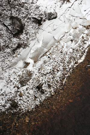 Shards of ice on the stone bank of the river in late autumn.の写真素材