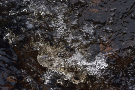 A raging stream of water in a swift stream.の写真素材