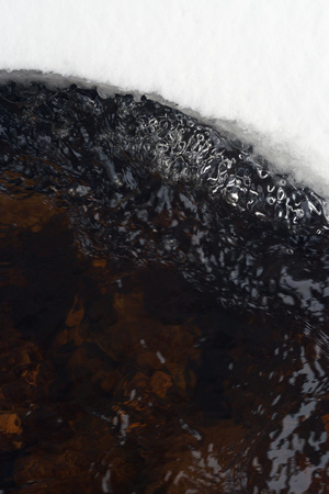 Spring melting of ice and the flow of water.の写真素材