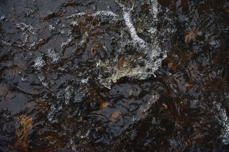 A raging stream of water in a swift stream.の写真素材