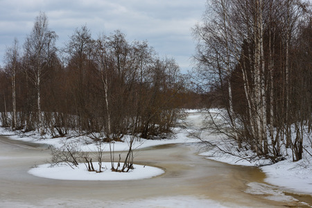 Spring landscape. Water emerges through the ice on the lake in mid-April.の写真素材